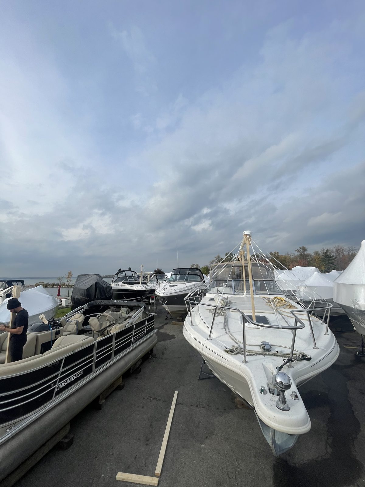 Boats lined up in the yard waiting to be shrink wrapped